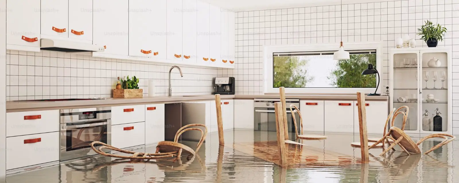 Apartment style white kitchen with an overturned chair and water on the floor
